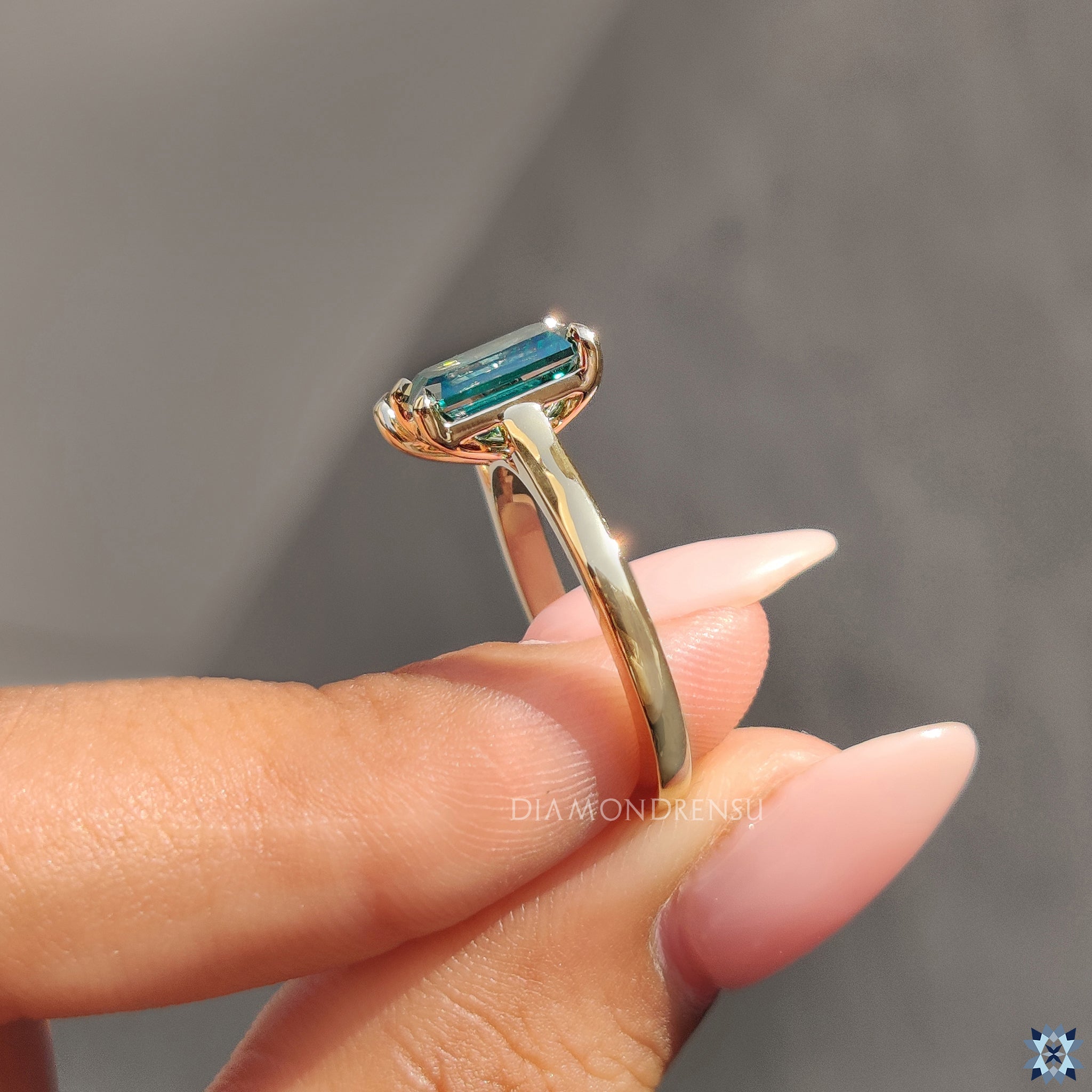 Yellow gold ring with emerald engagement ring
