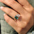 2 stone ring in emerald and pear cut ring design
