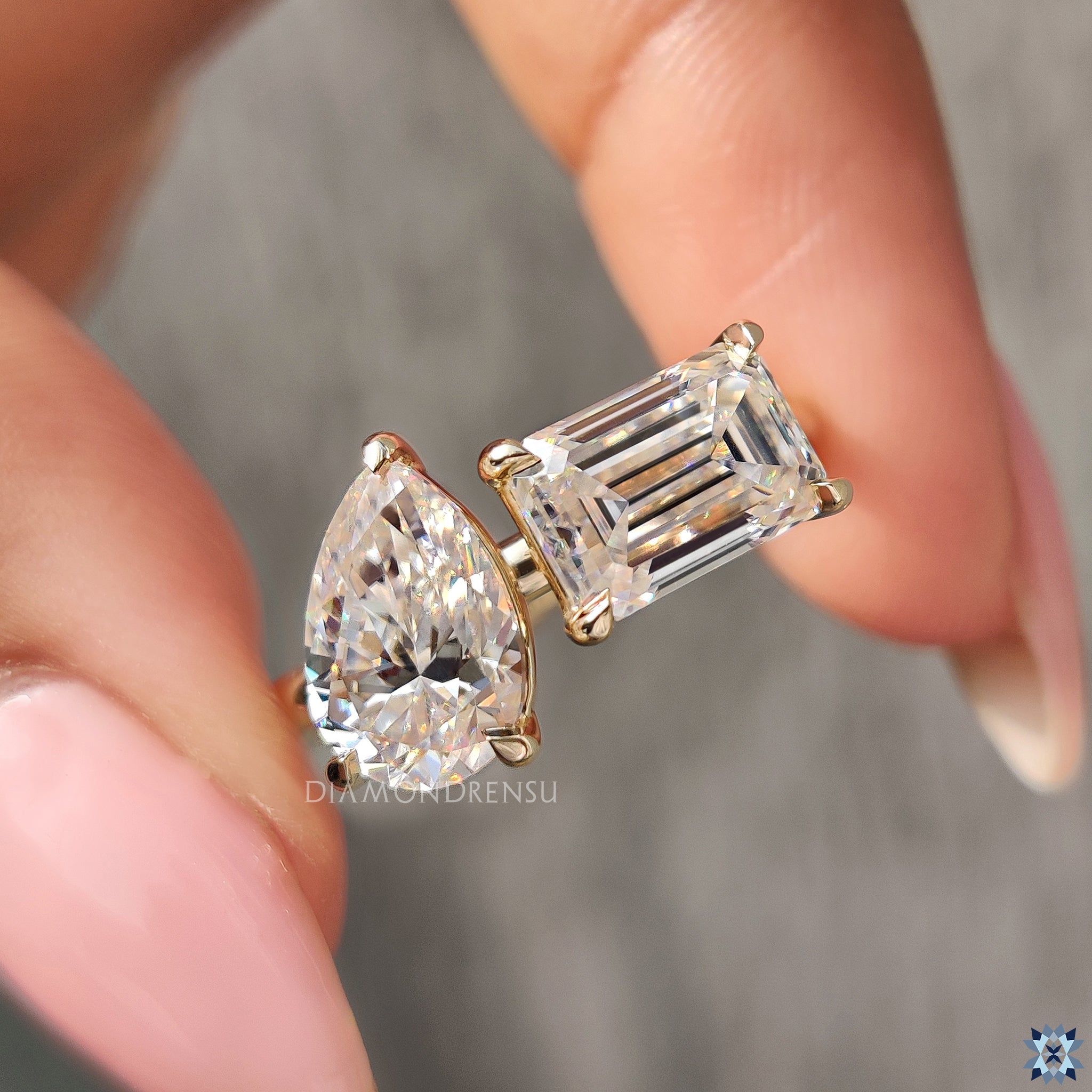 Handmade ring with 2 stone moissanite and yellow gold claw setting.
