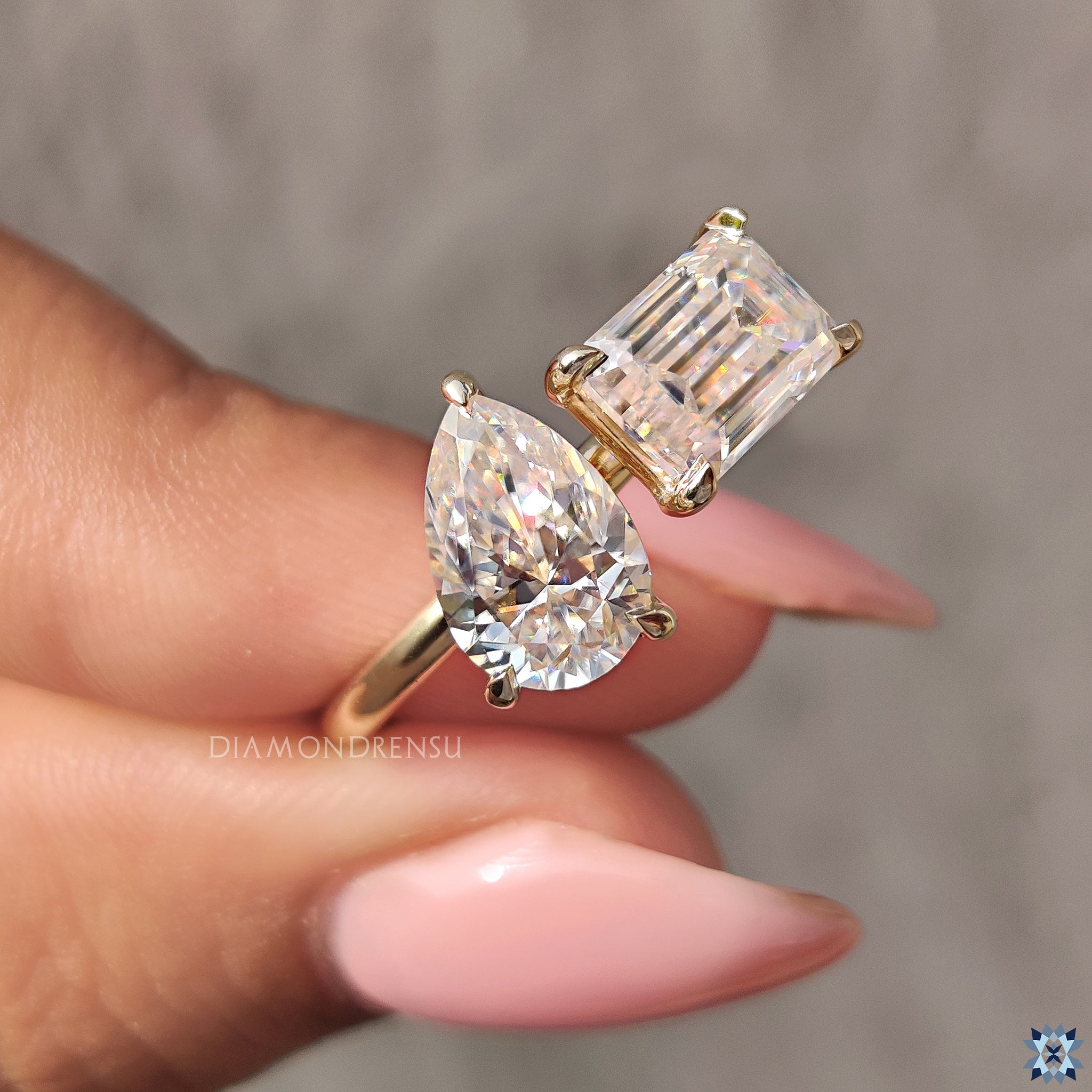 Custom engagement ring with toi et moi pear and emerald cuts.
