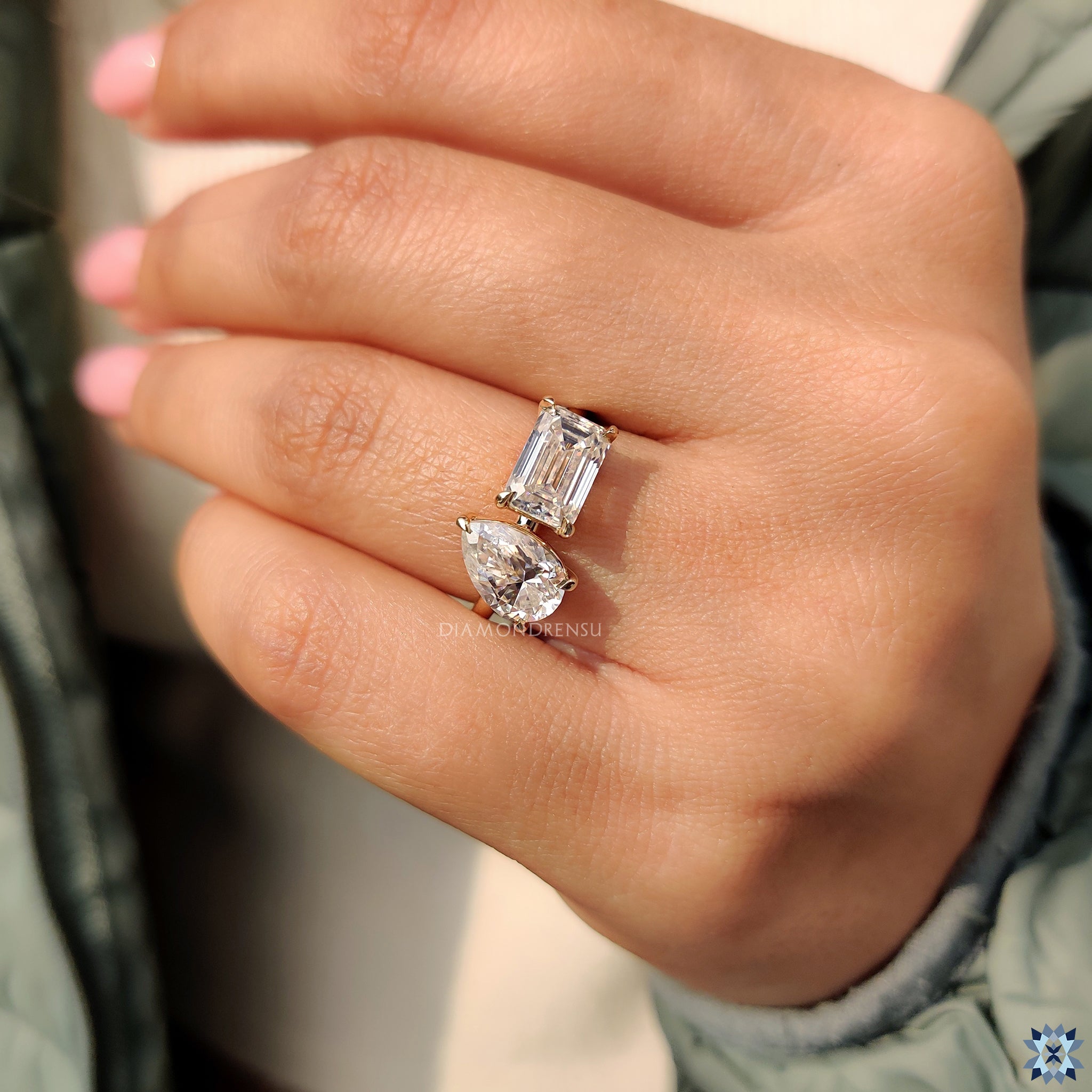 2 stone moissanite ring featuring handmade claw prong yellow gold band.
