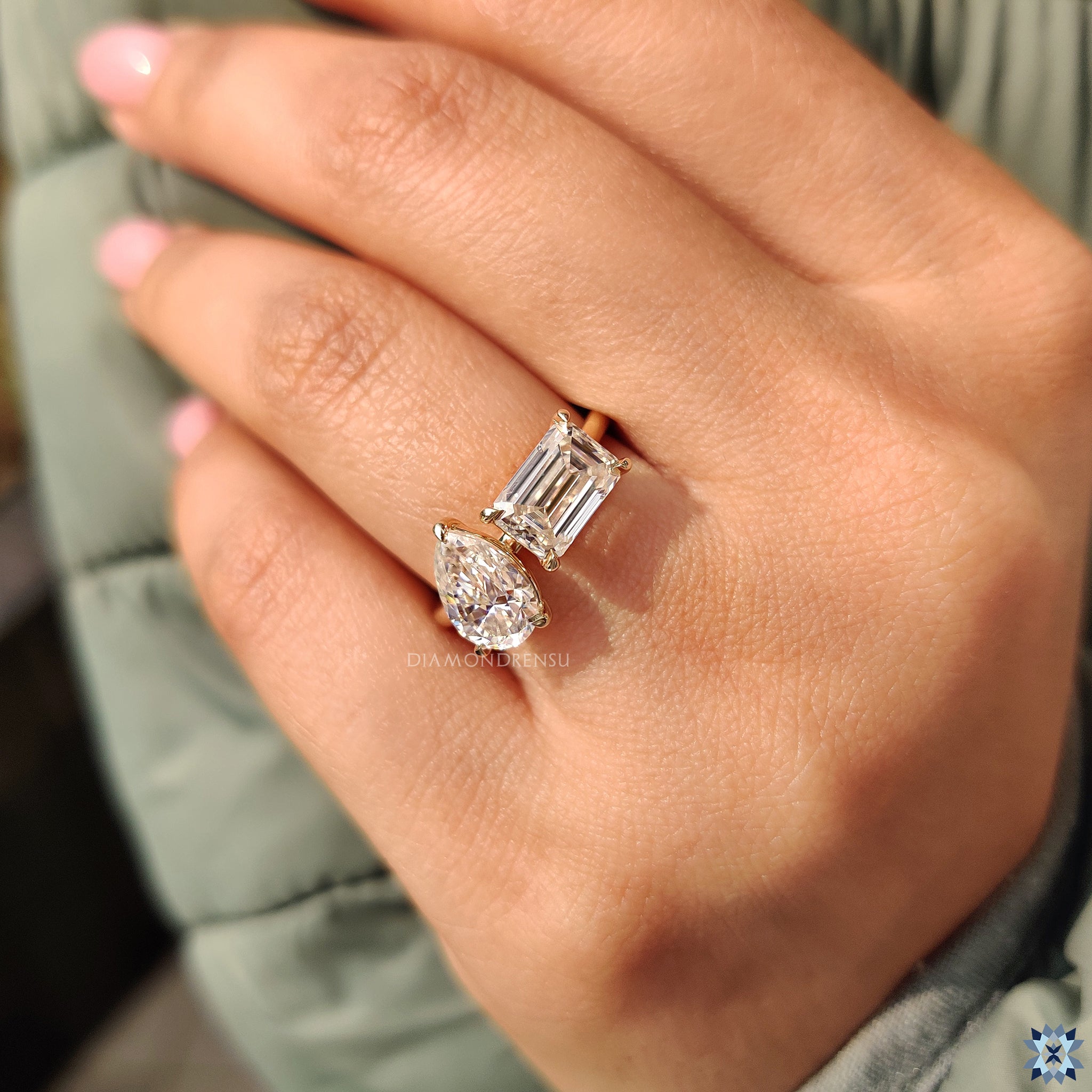 Moissanite ring UK style with pear and emerald cut stones.

