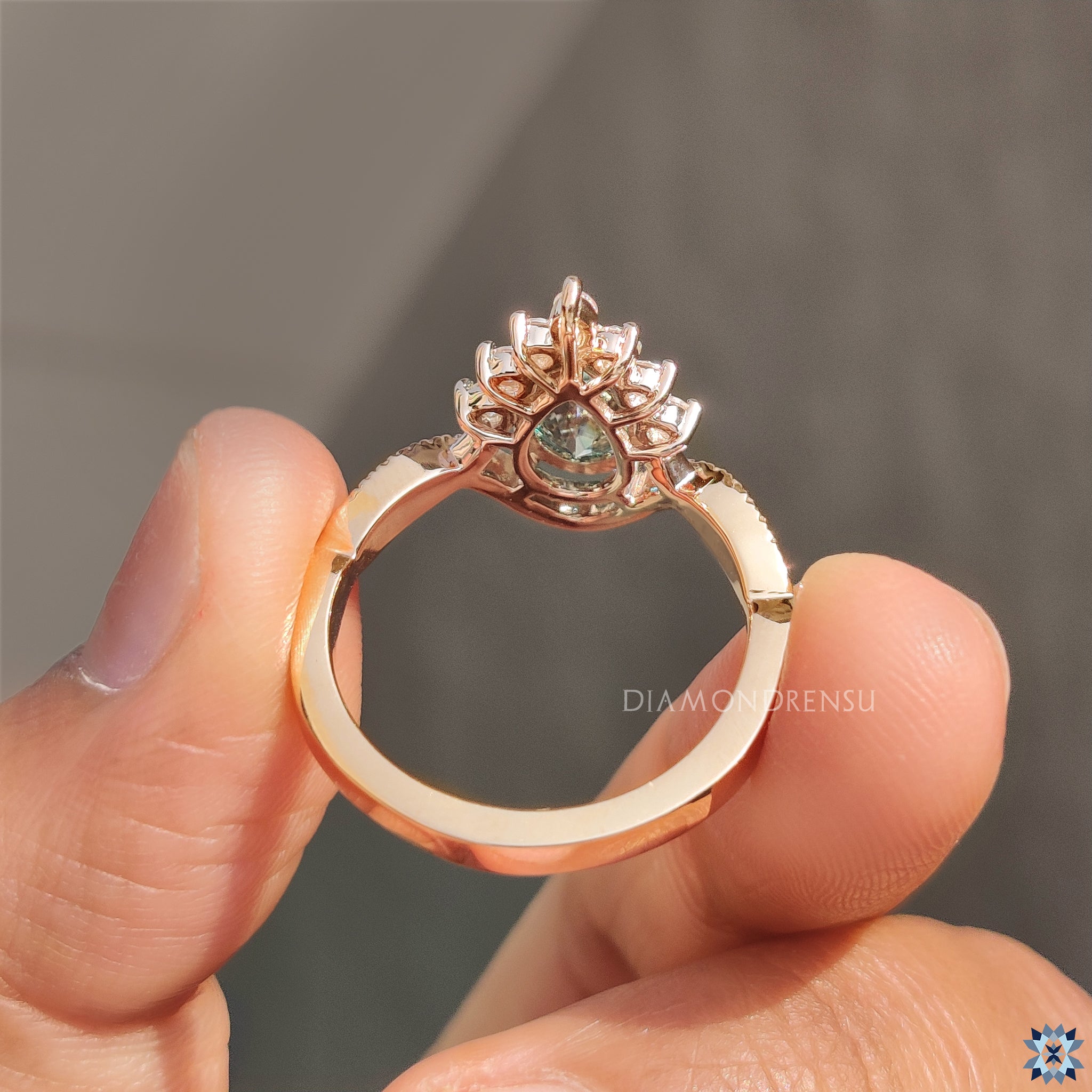Yellow gold halo engagement ring with twisted pave band.
