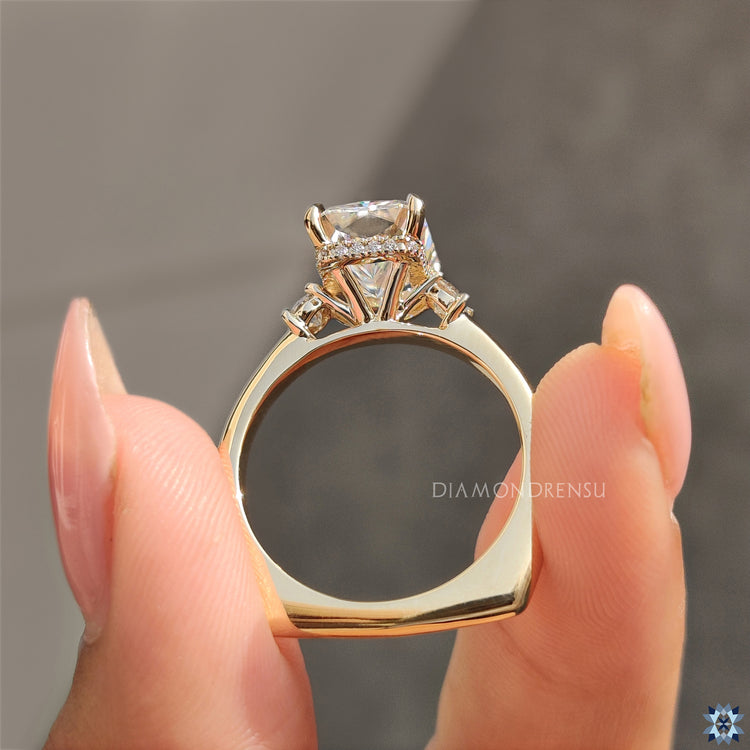 Custom engagement ring with yellow gold band and round moissanite accents.
