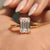Emerald moissanite ring with double claw prong in yellow gold setting.
