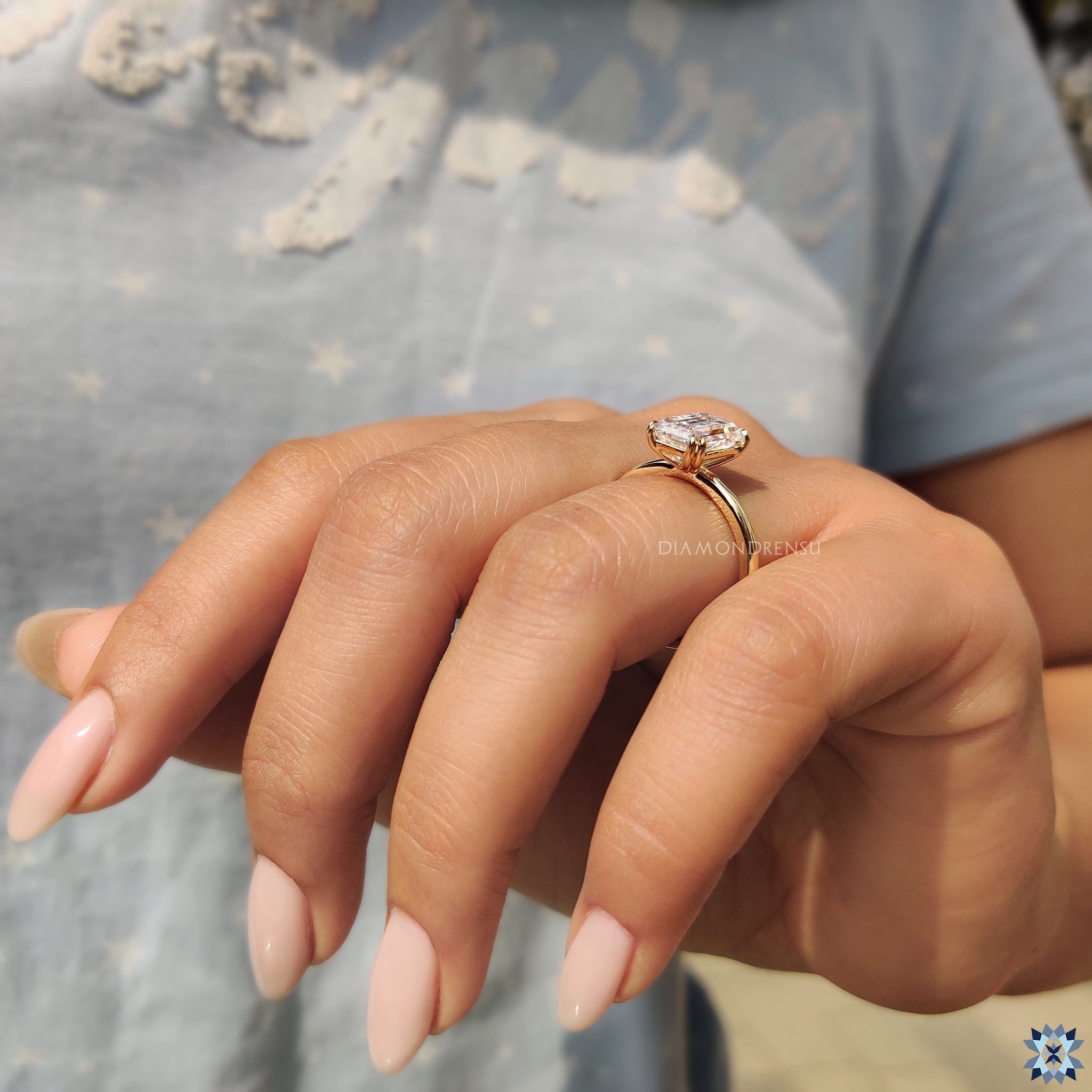 Moissanite ring UK with emerald solitaire and double claw prongs.
