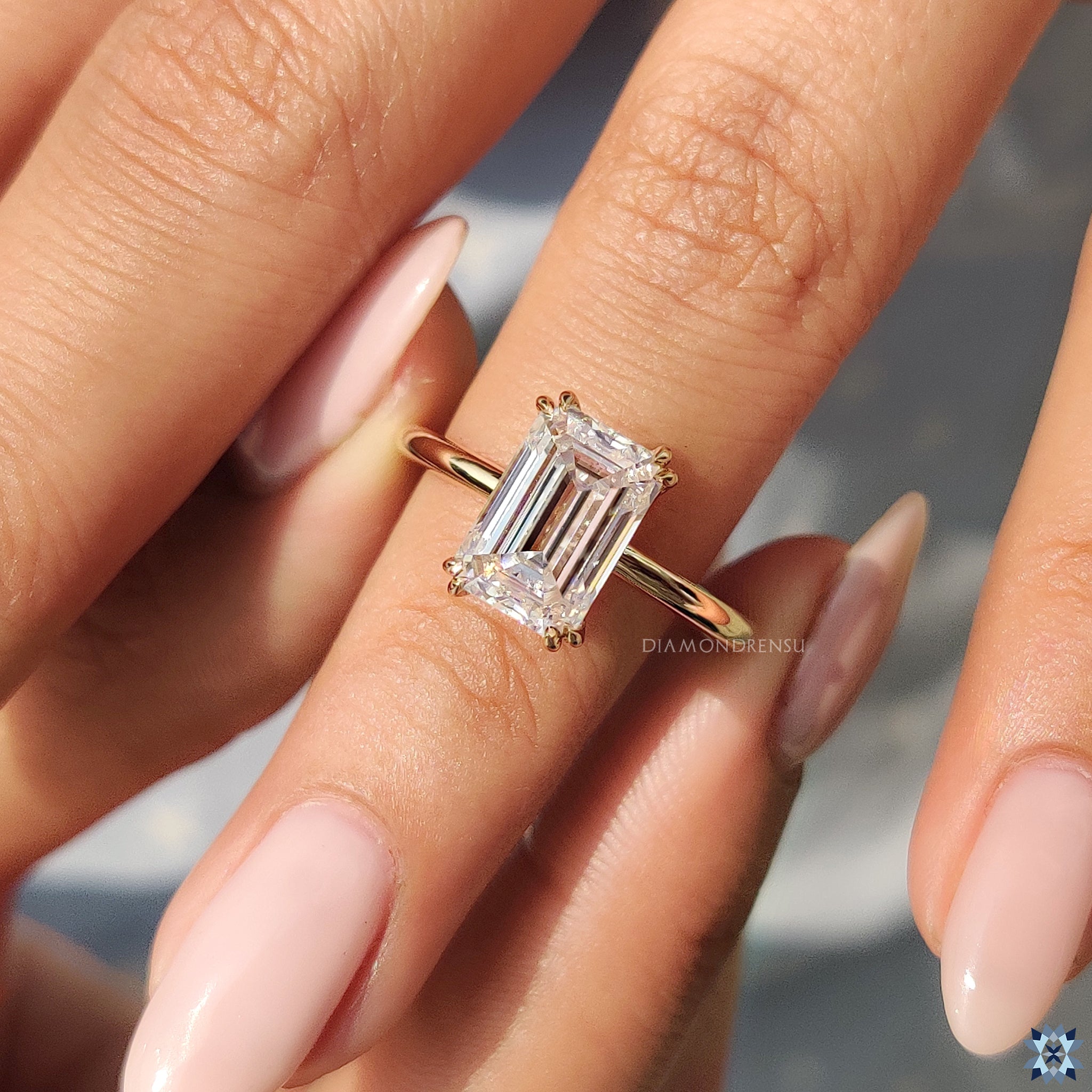 Handmade ring with emerald moissanite in classic solitaire yellow gold setting.
