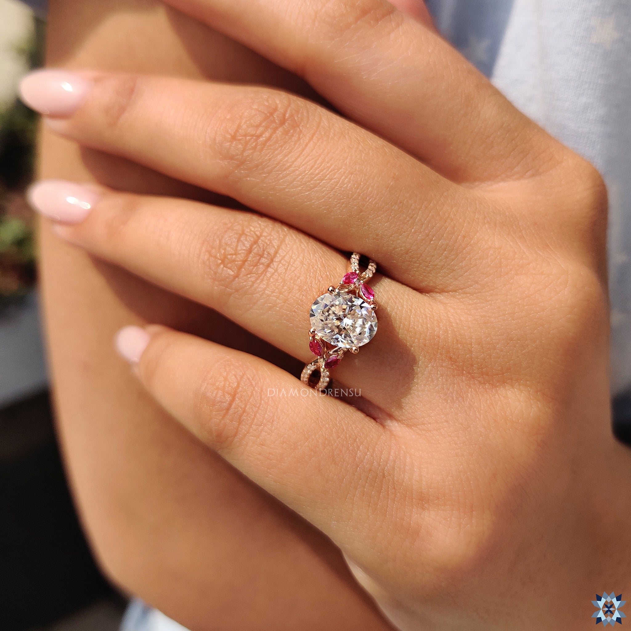 Handmade jewellery with oval moissanite centre and bold side stone accents.
