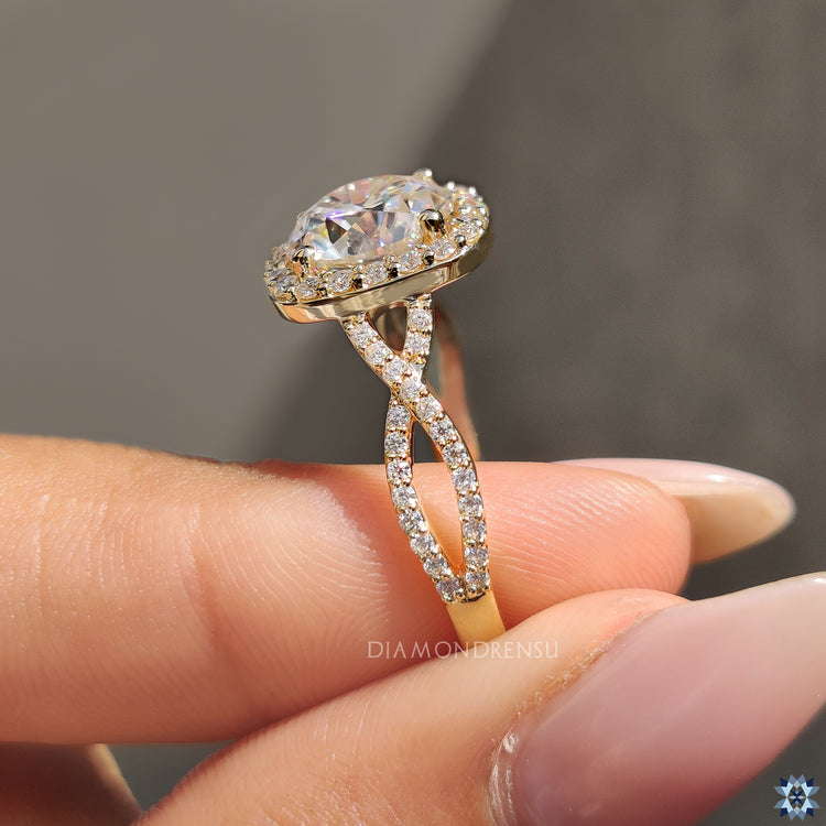 Round cut halo with moissanite in yellow gold prong setting.
