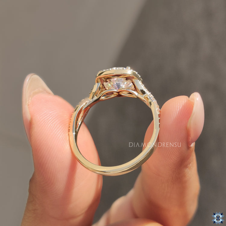 Prong setting ring featuring moissanite halo and round cut pave band.
