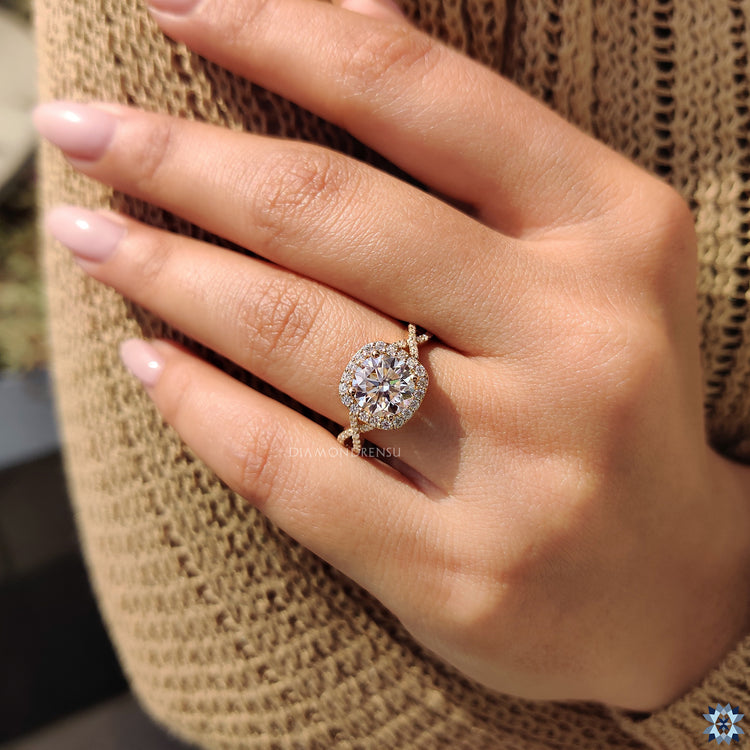 Yellow gold moissanite ring with twisted pave and round cut design.
