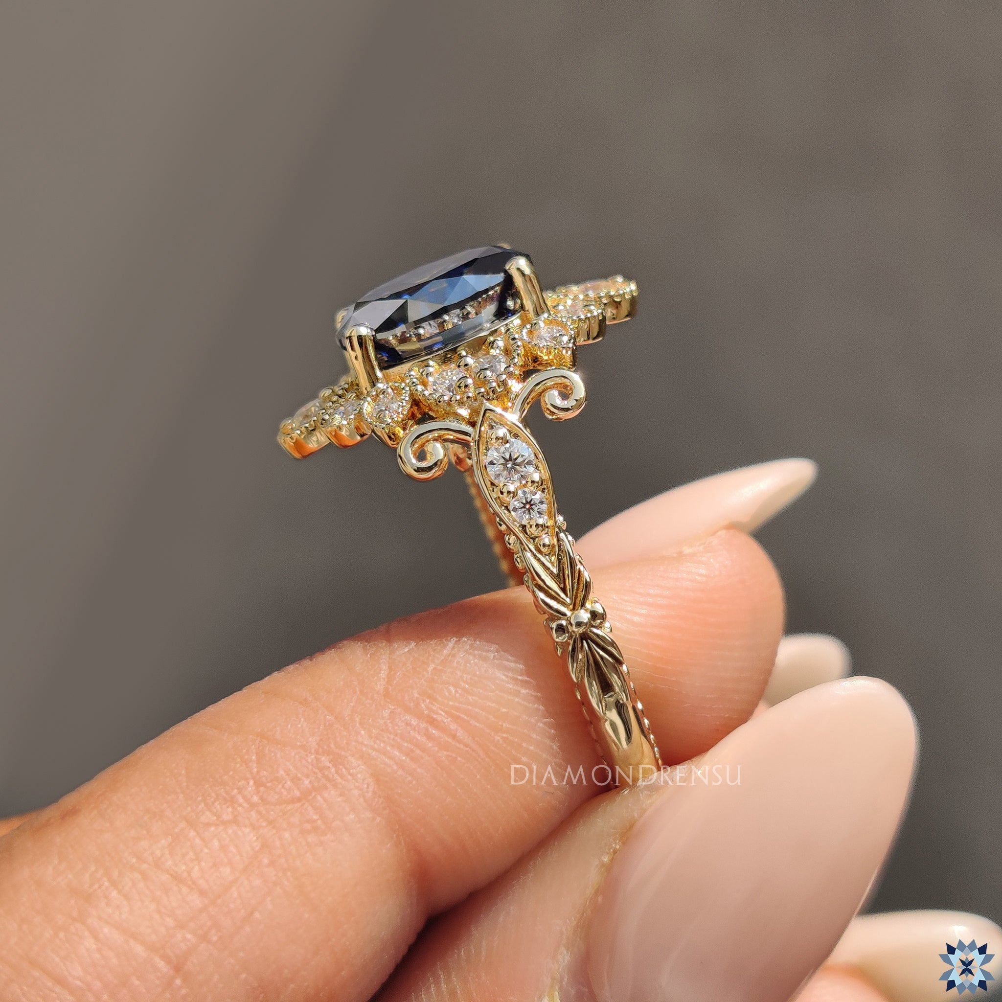 Milgrain ring with blue oval moissanite in custom engagement style.
