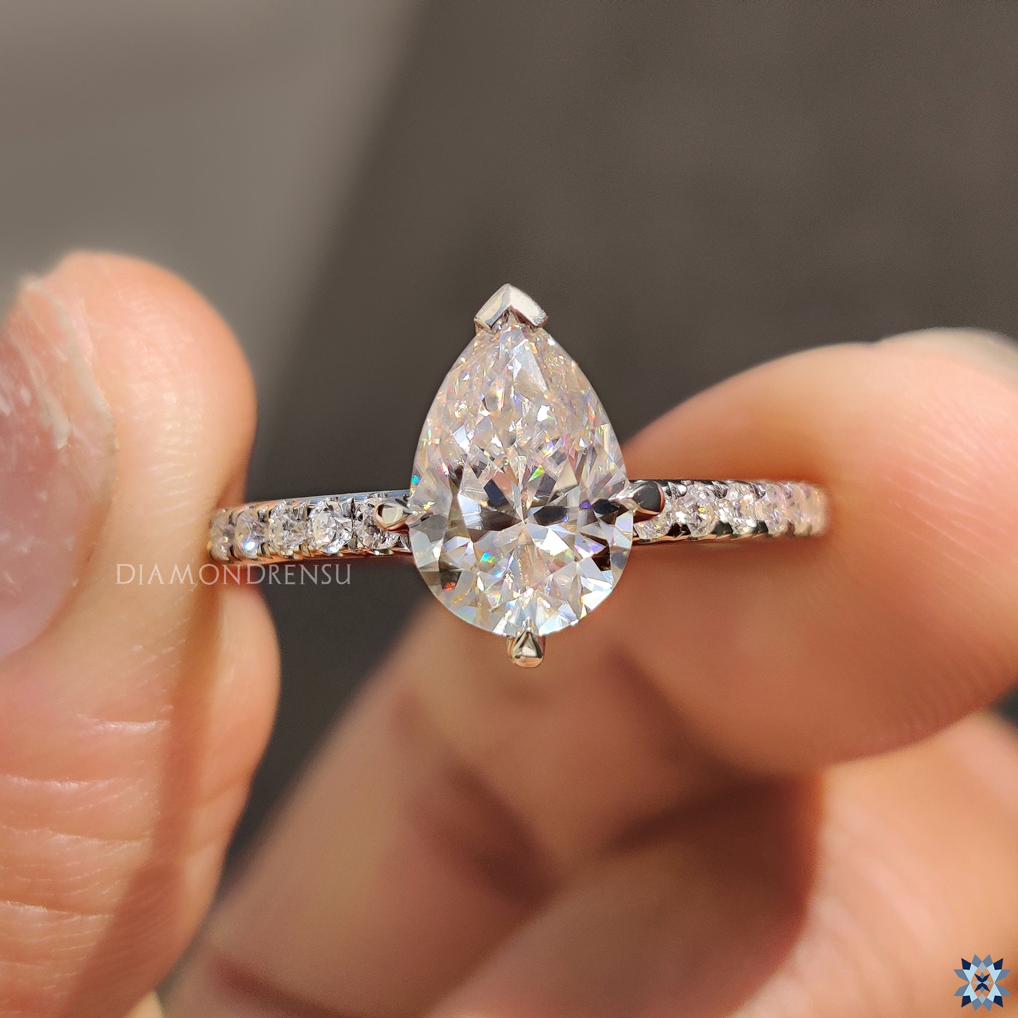 White gold moissanite ring with custom pear shaped centre stone.
