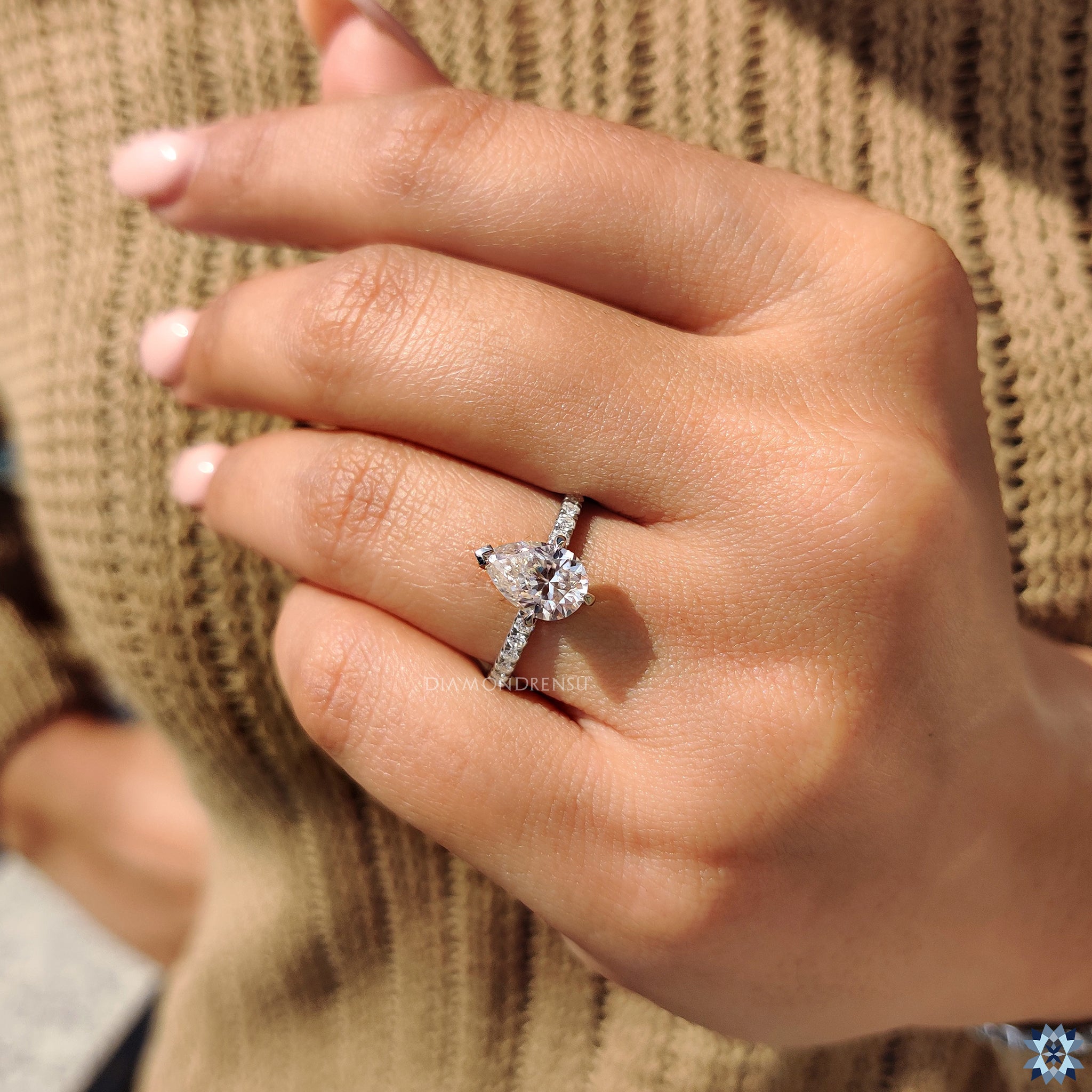 Claw prong ring with moissanite pave details and round cut design.
