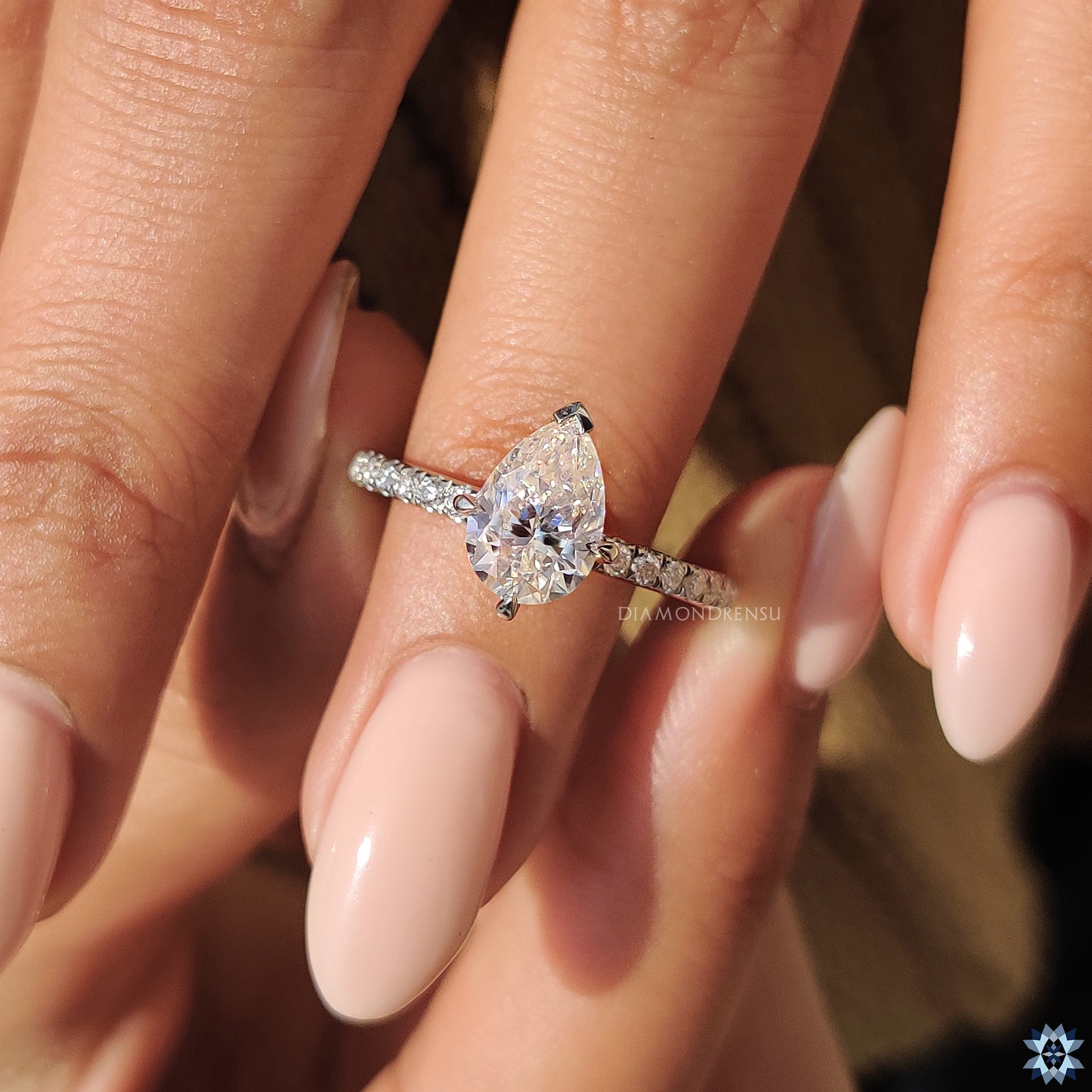 Moissanite ring UK style with pear centre and handmade pave setting.
