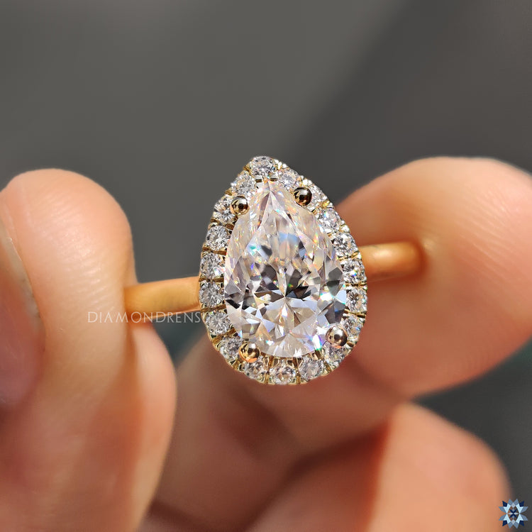 Yellow gold moissanite ring with 4 prong setting and custom design.
