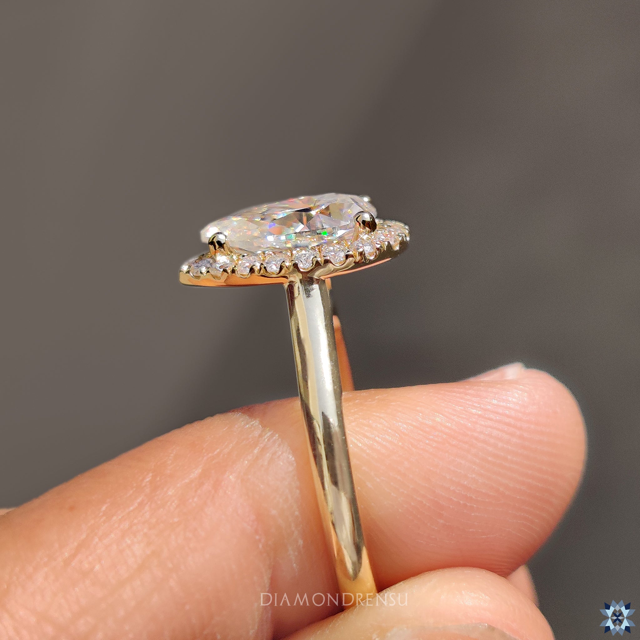 Moissanite engagement ring with 4 prong setting and yellow gold band.
