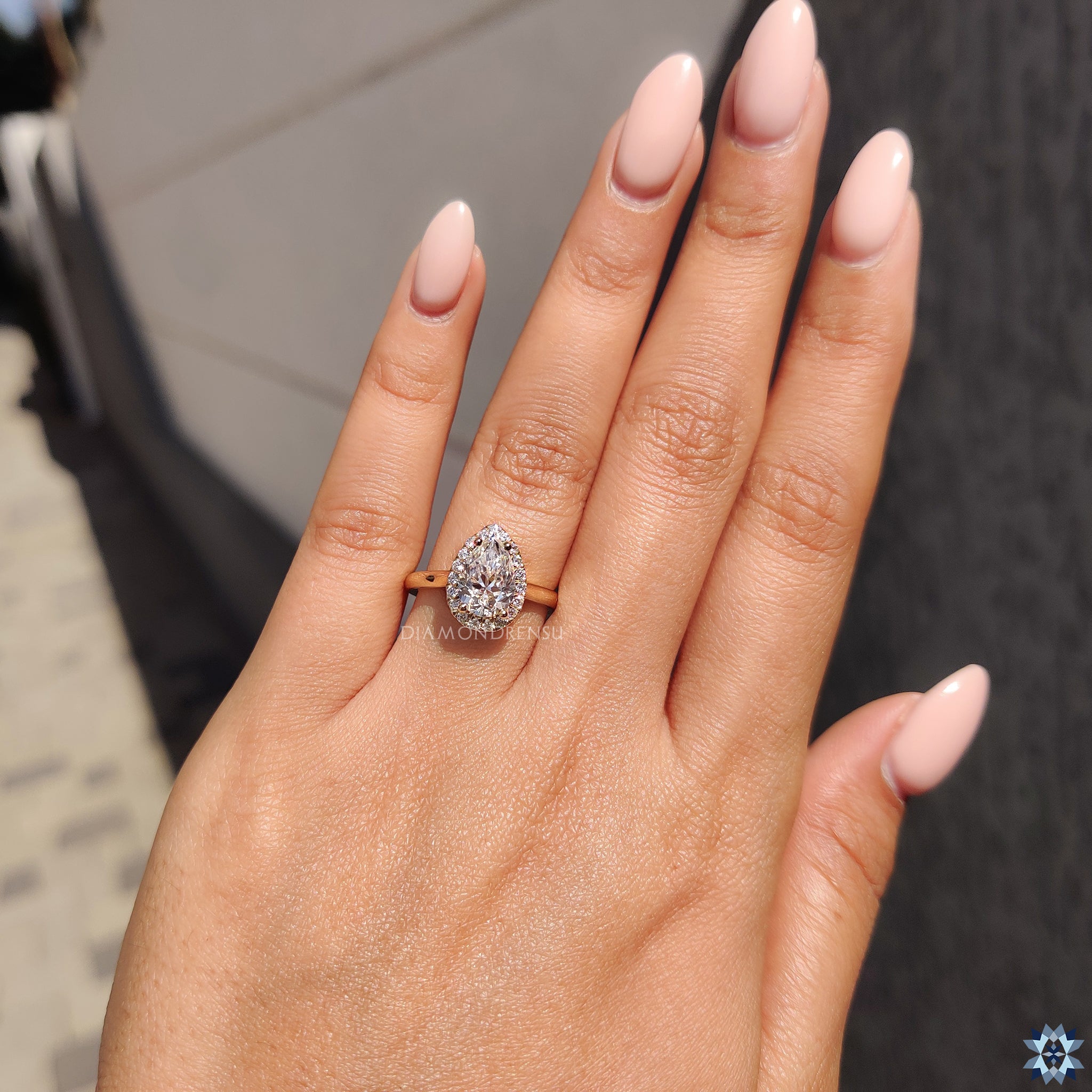 Cathedral setting ring with pear moissanite and yellow gold design.

