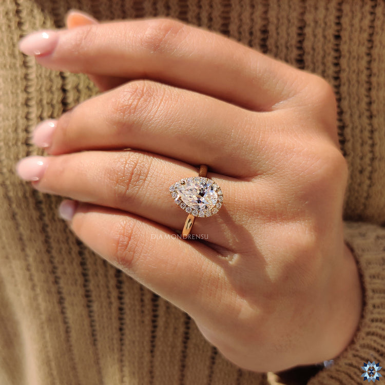 4 prong setting ring with moissanite pear cut and cathedral mount.
