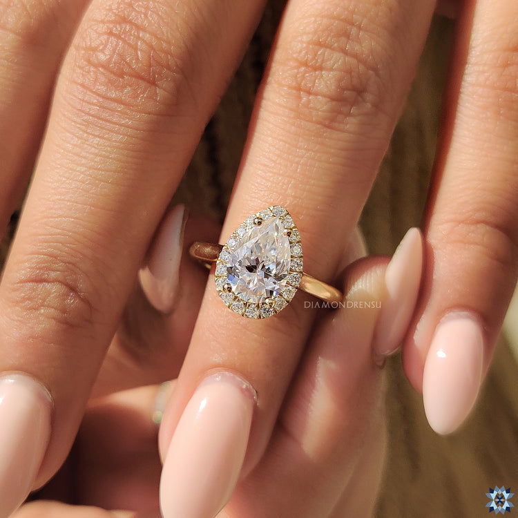 Handmade ring with cathedral setting and pear moissanite centre stone.
