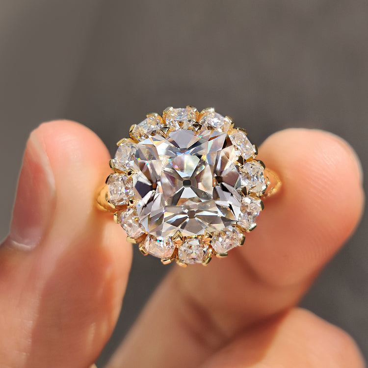 Cushion old mine cut moissanite ring in yellow gold.
