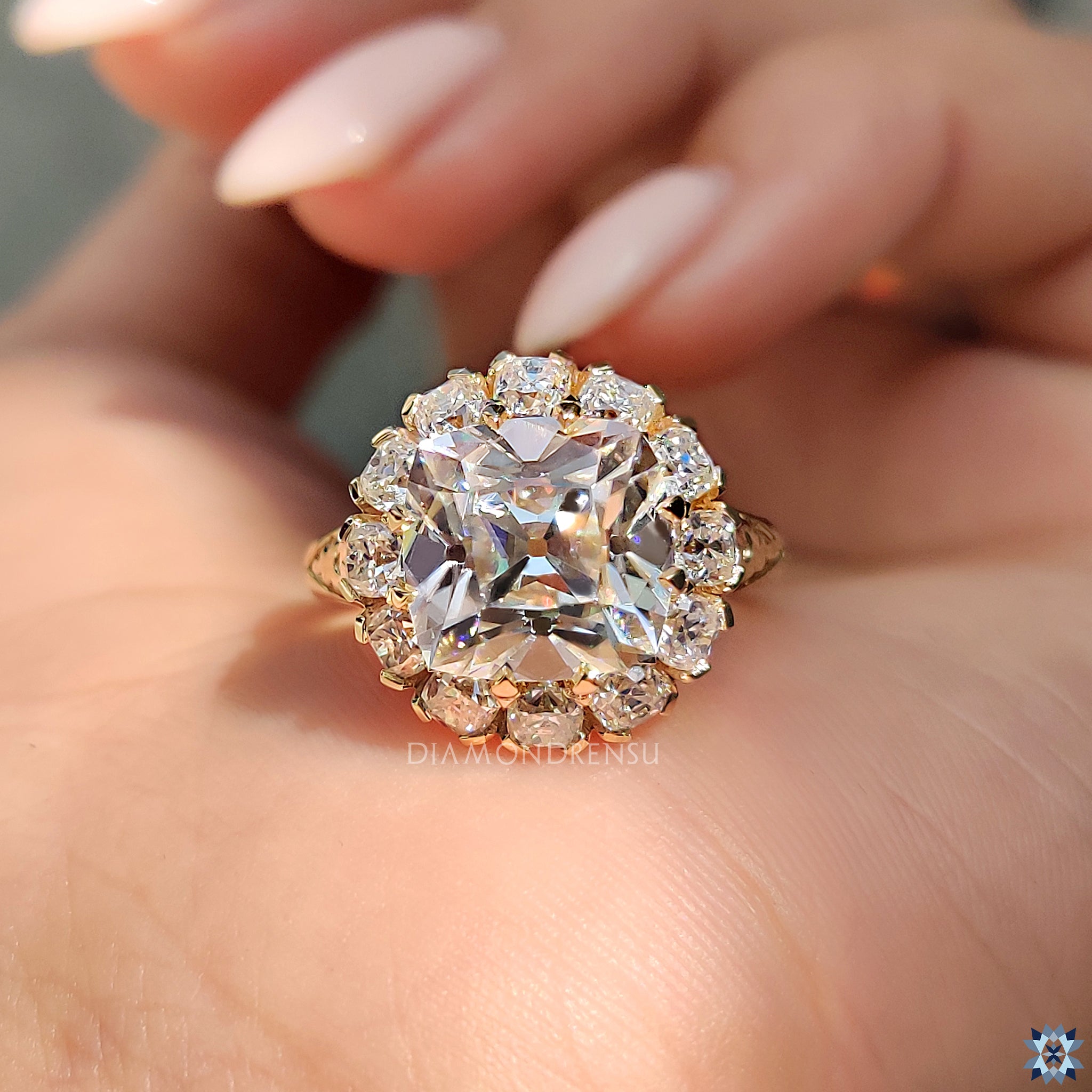 Handmade yellow gold ring with cushion cut moissanite.
