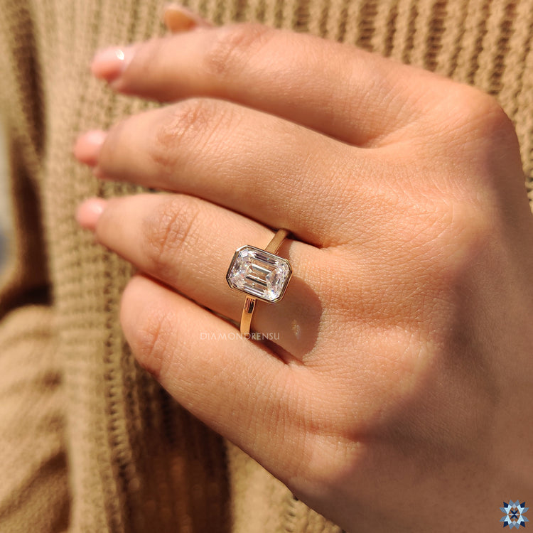 Moissanite ring in emerald cut engagement ring setting
