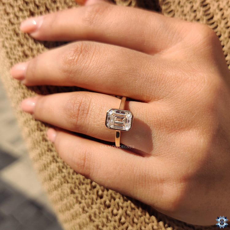 Bezel set engagement ring in emerald cut ring style
