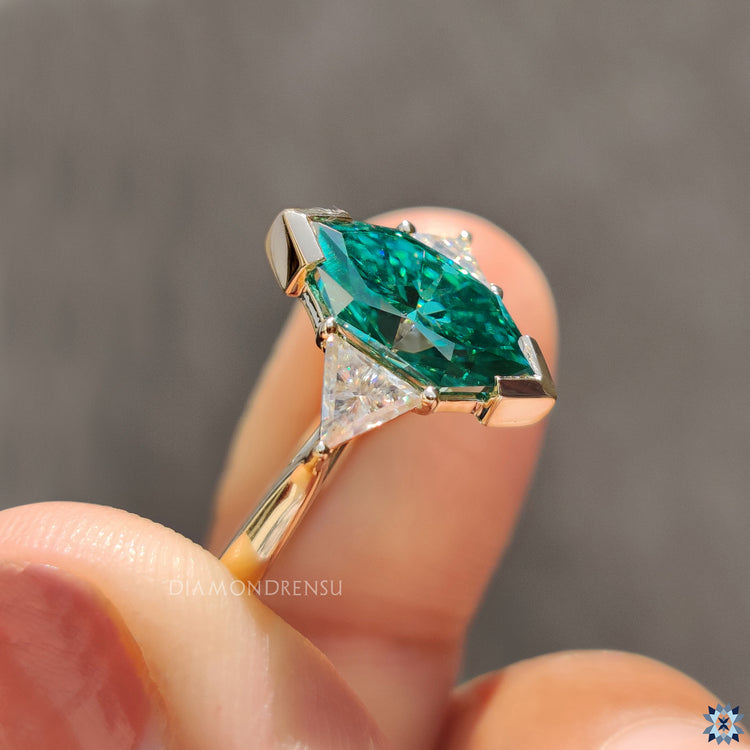 Yellow gold moissanite ring handmade with Dutch marquise and prong detail.
