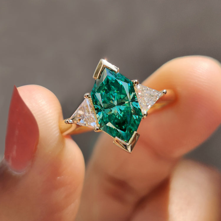 3 stone engagement ring with green Dutch marquise moissanite and triangle sides.
