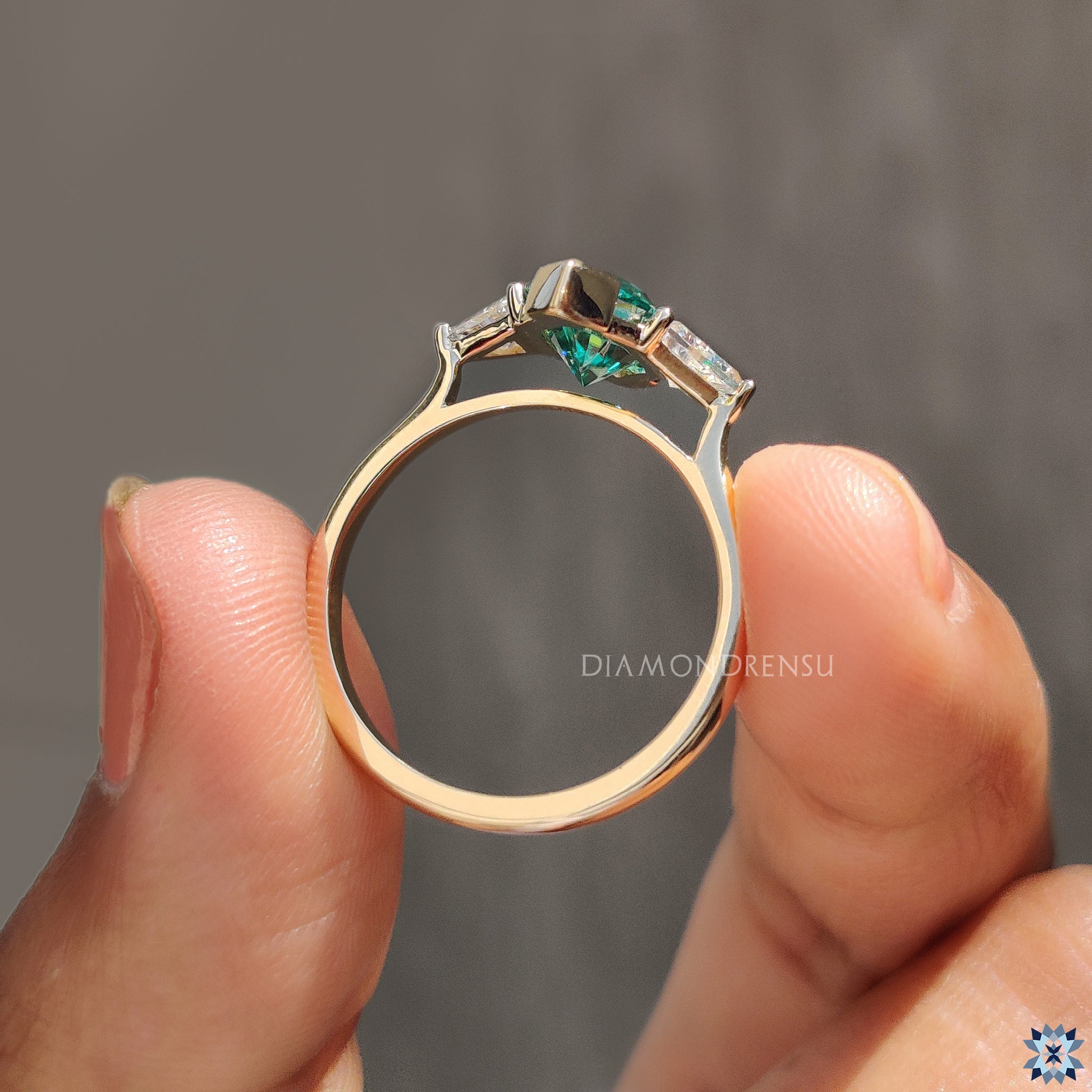 Moissanite engagement ring in a 3 stone design with unique tapered shank.
