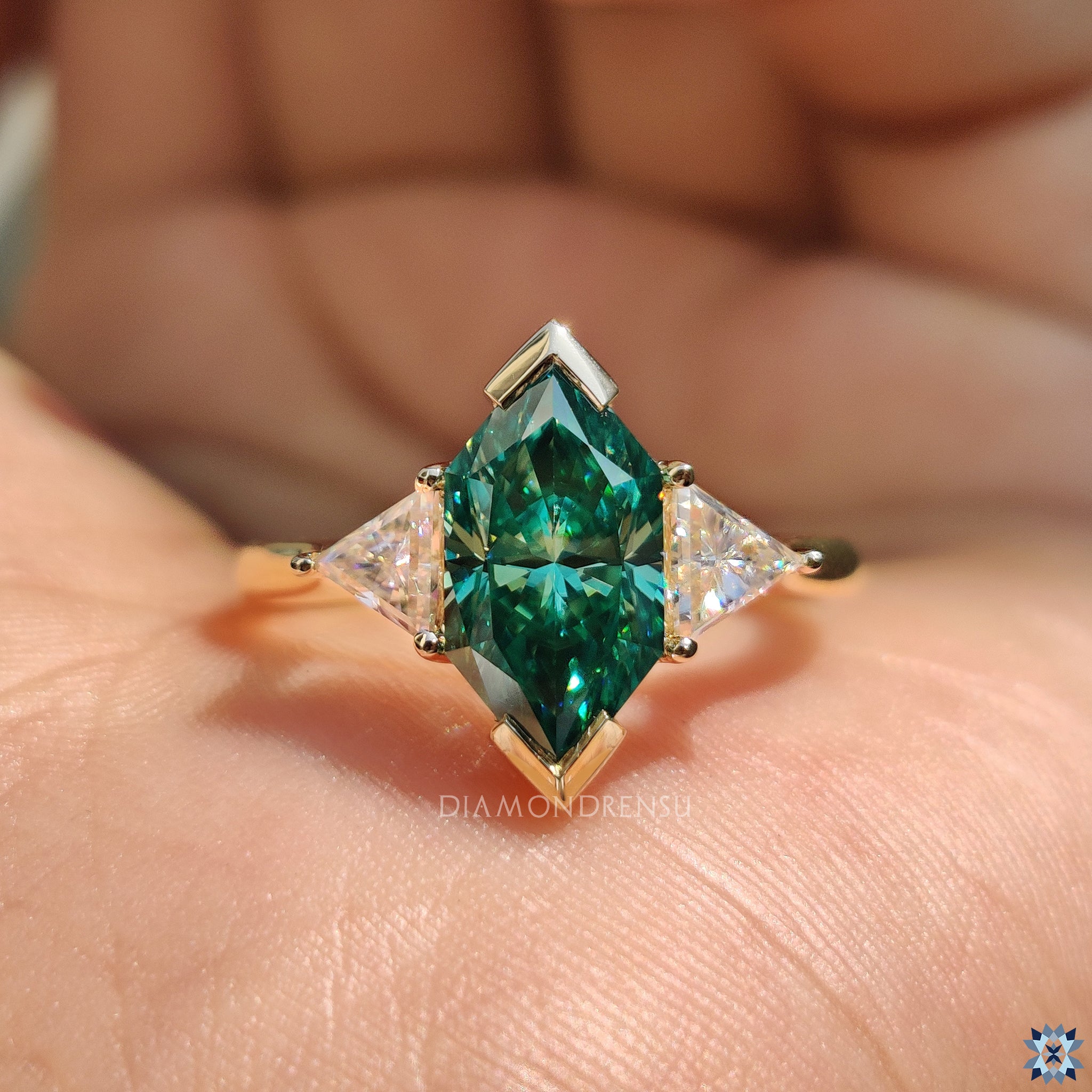 Handmade ring featuring V shaped prong setting and triangle side stones.
