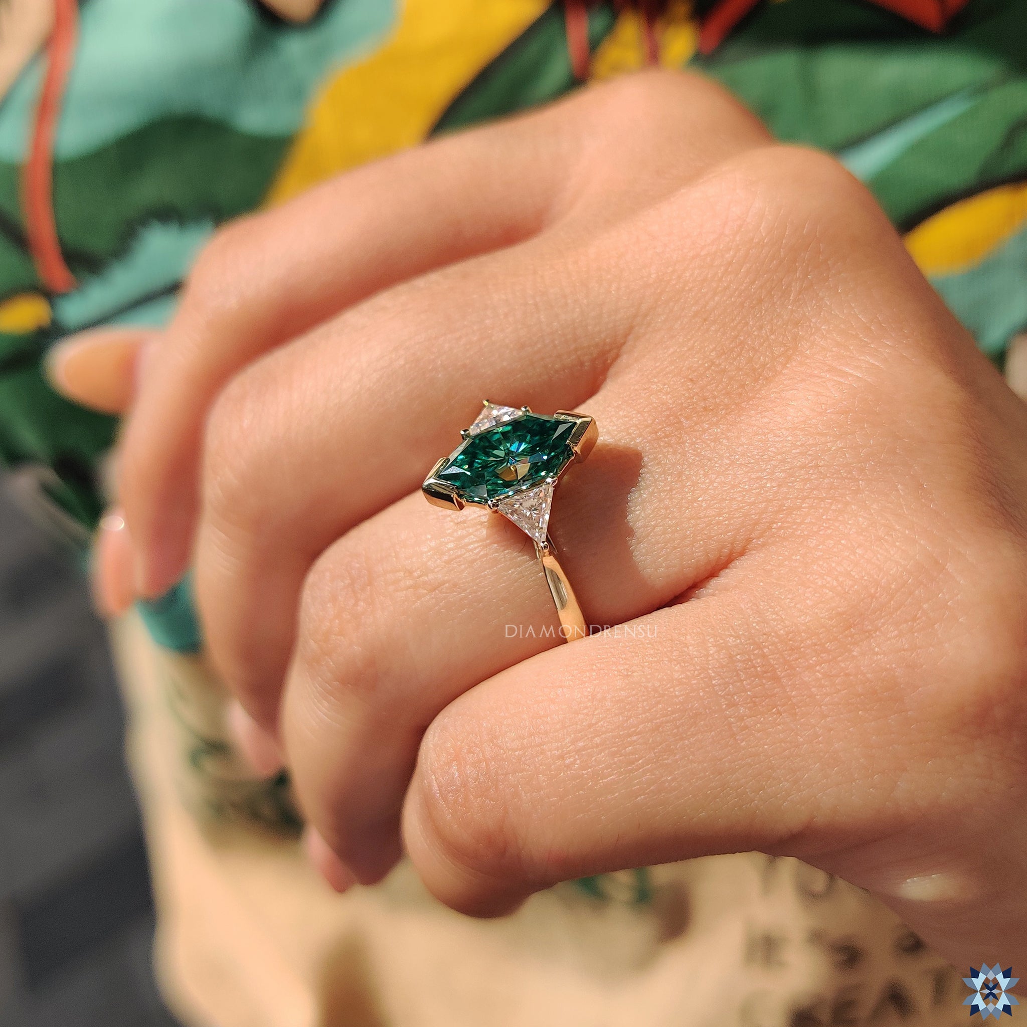 Triangle side stone ring with green Dutch marquise centre and custom setting.
