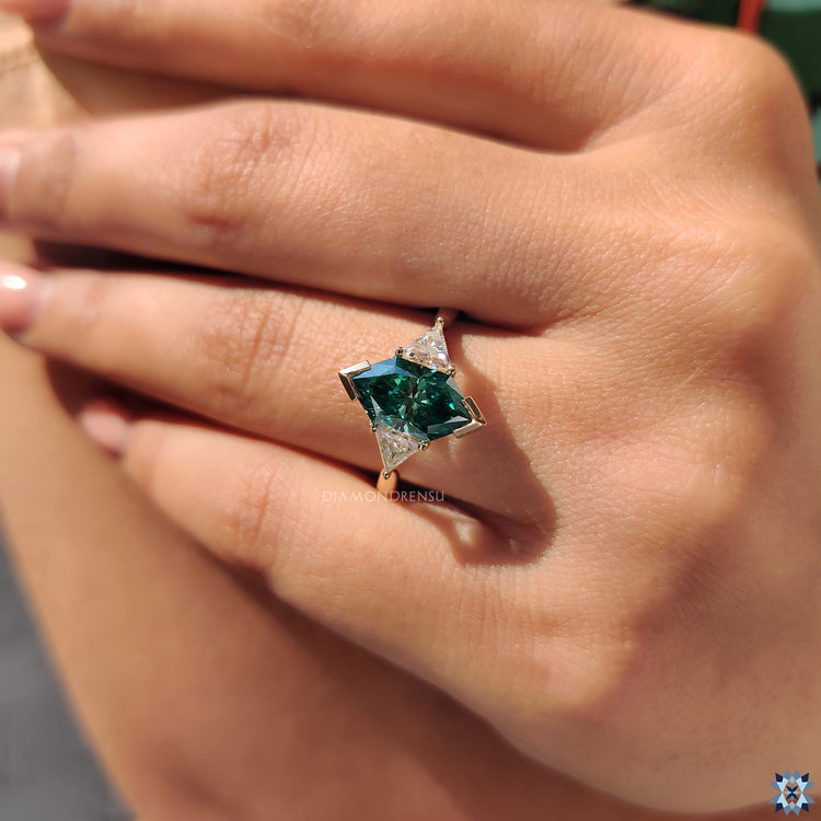 Moissanite ring UK crafted with tapered shank and three stone layout.
