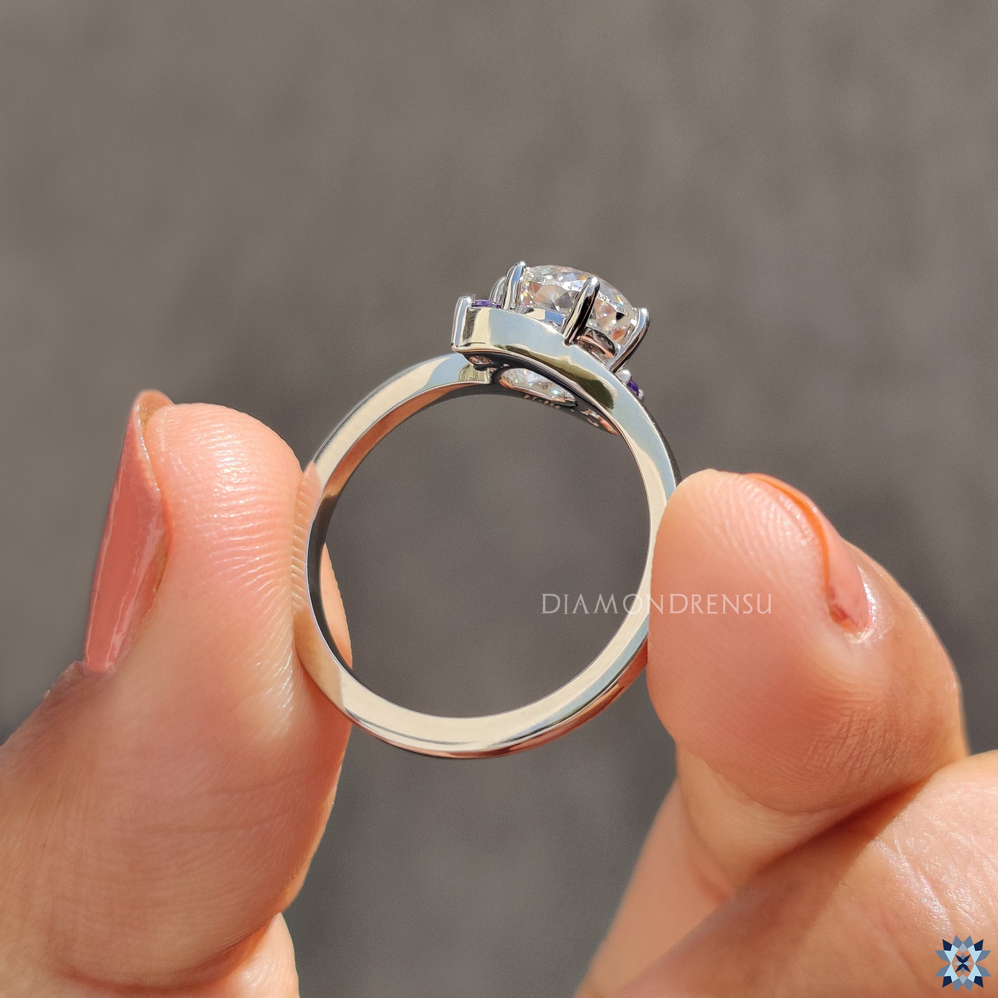 Custom engagement ring with a purple moissanite and rose cut trio design.
