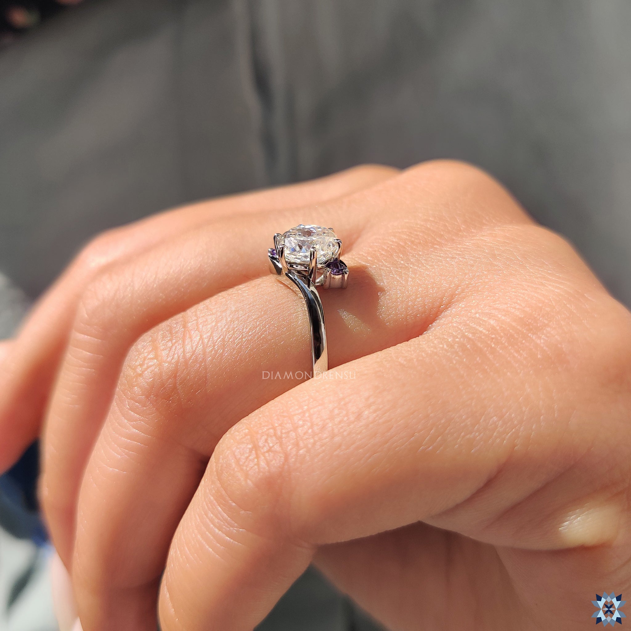 Diamondrensu UK ring crafted in white gold with three moissanite stones.
