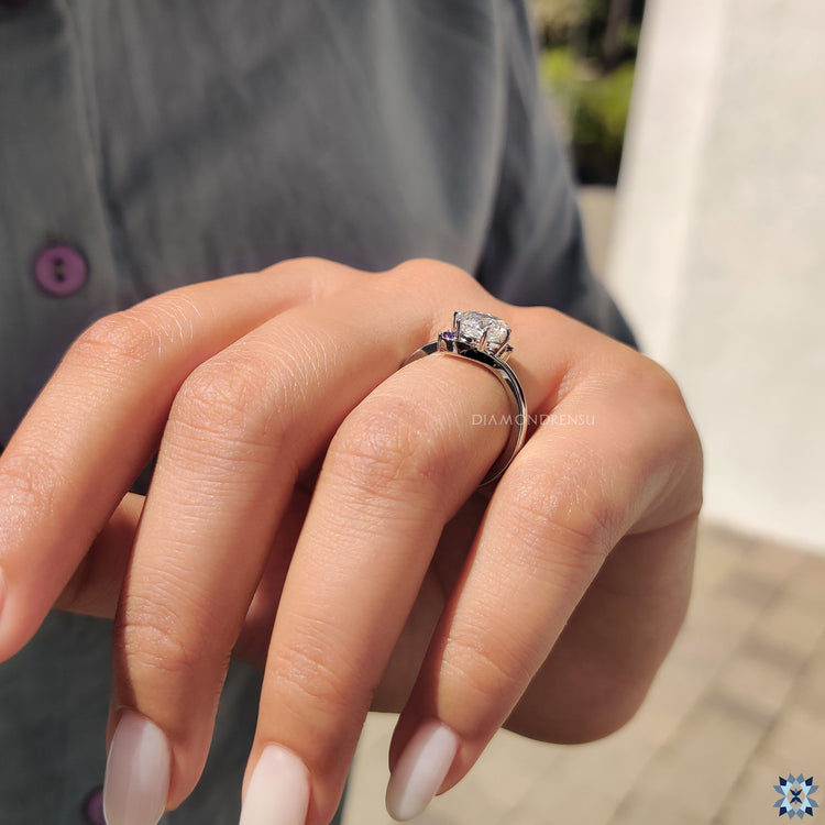 Handmade jewellery with purple moissanite and elegant bypass setting.
