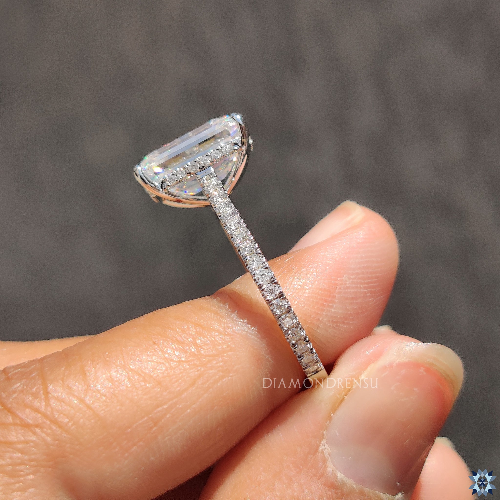 Moissanite ring UK made with hidden halo and round pave accents.
