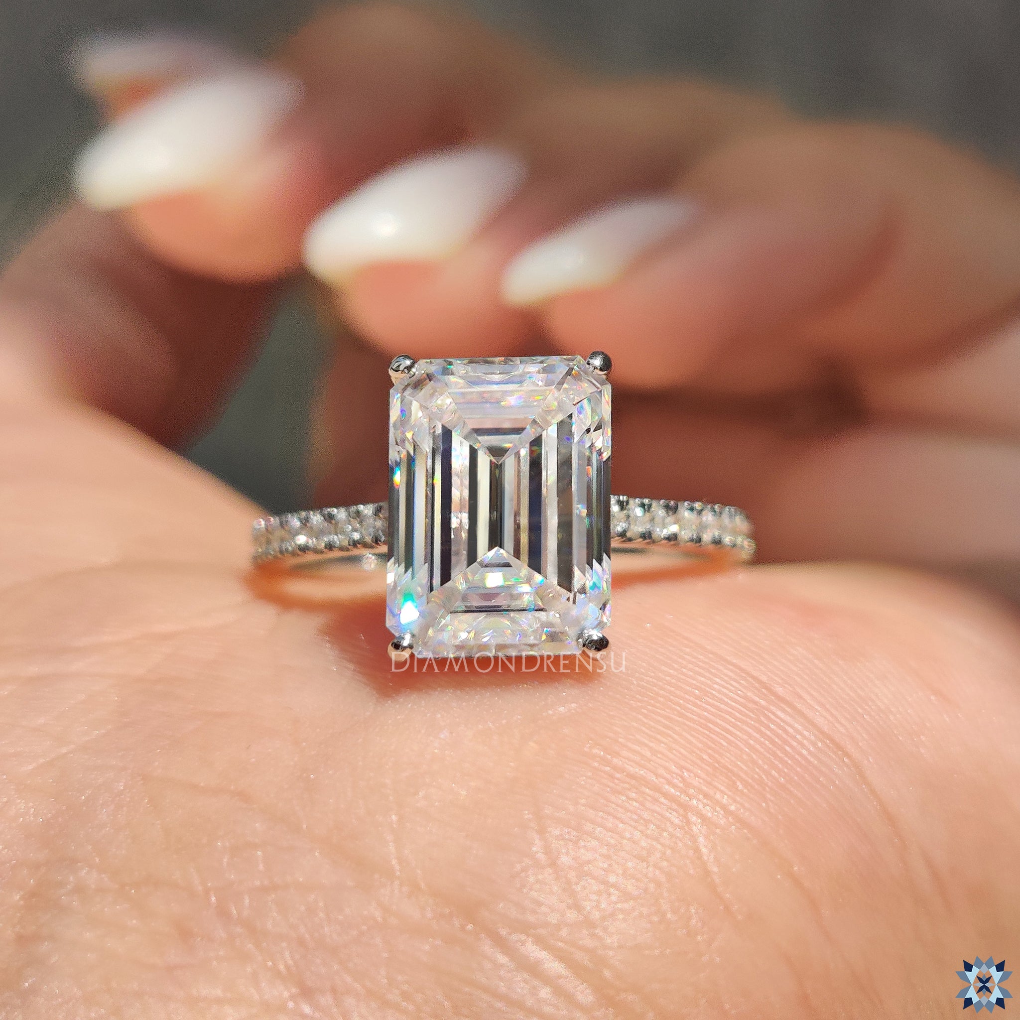 Moissanite engagement ring in white gold with hidden halo design.
