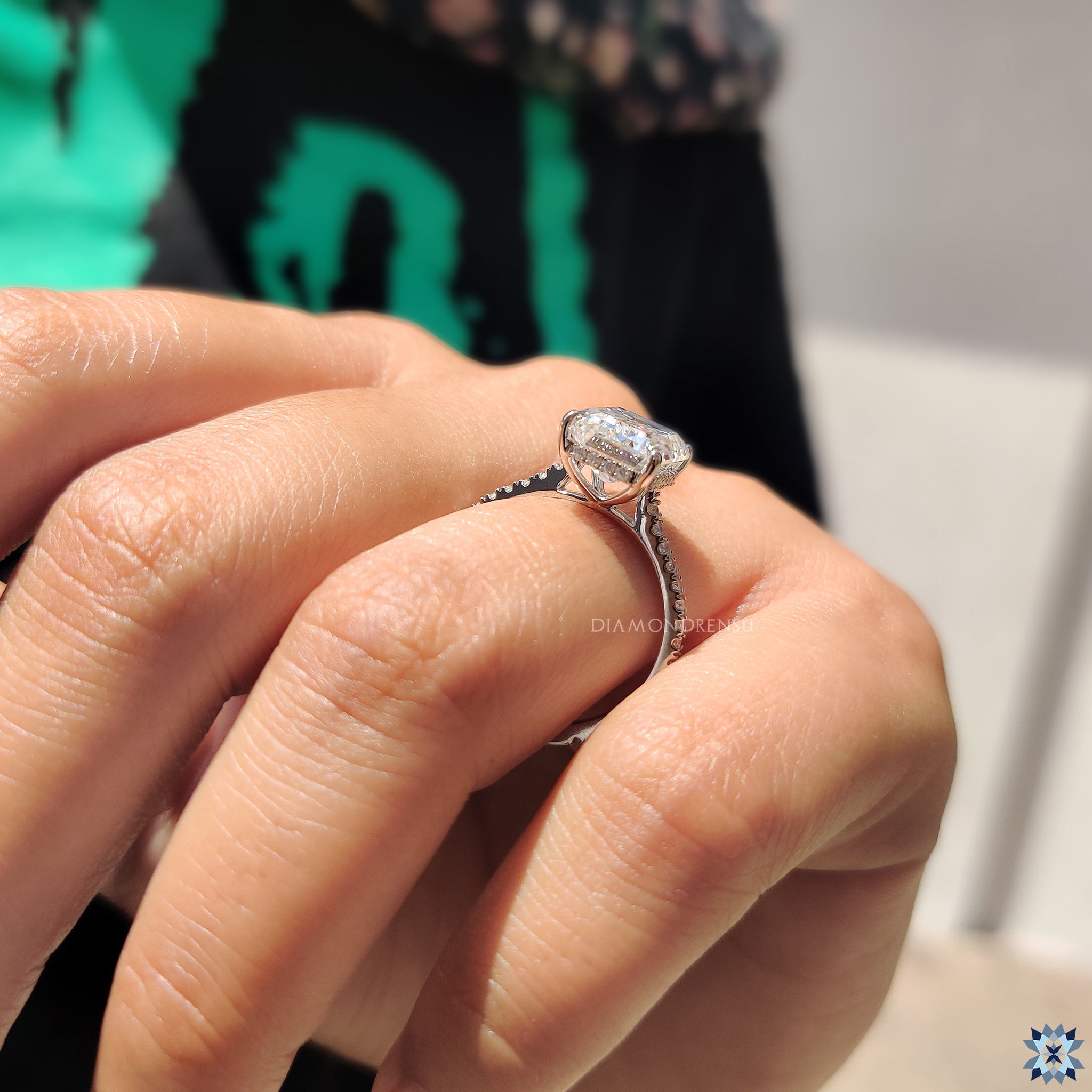 White gold ring featuring pave setting and moissanite centre stone.
