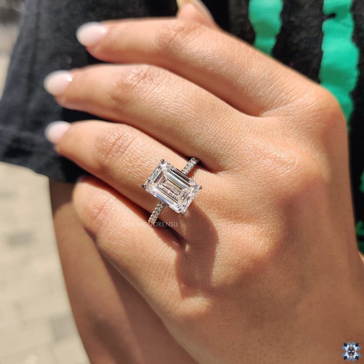 Handmade ring featuring pave setting and emerald cut moissanite centre.
