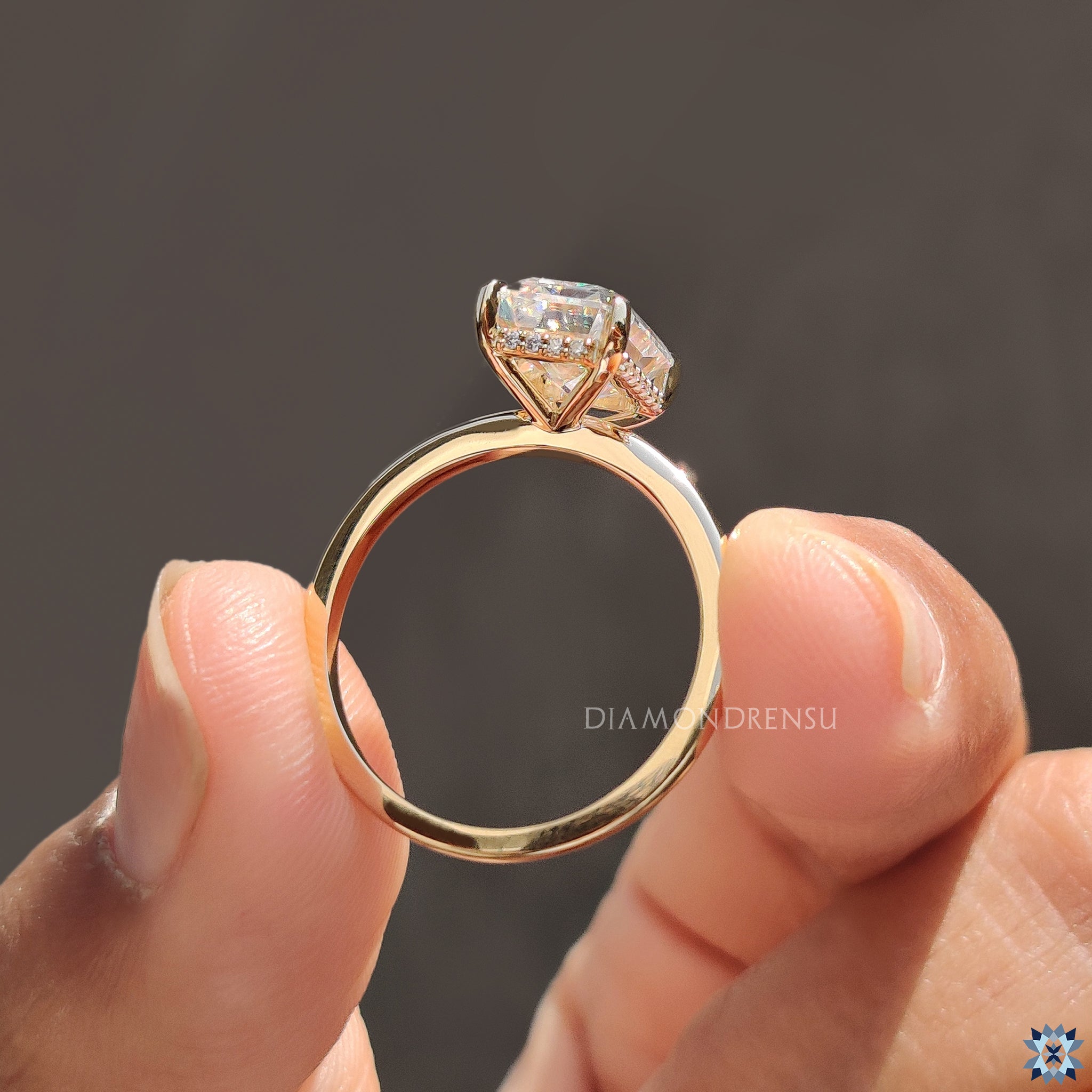 Moissanite ring UK made with yellow gold and secure 4 tab prongs.
