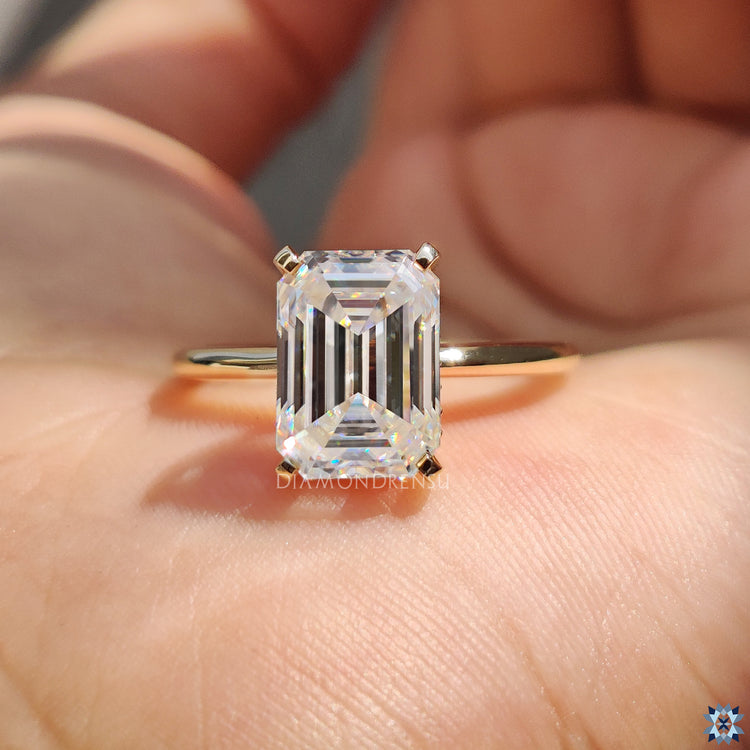 Yellow gold moissanite ring with a hidden halo and 4 tab prong setting.
