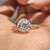 Moissanite pave ring in yellow gold with a round old European cut centre.
