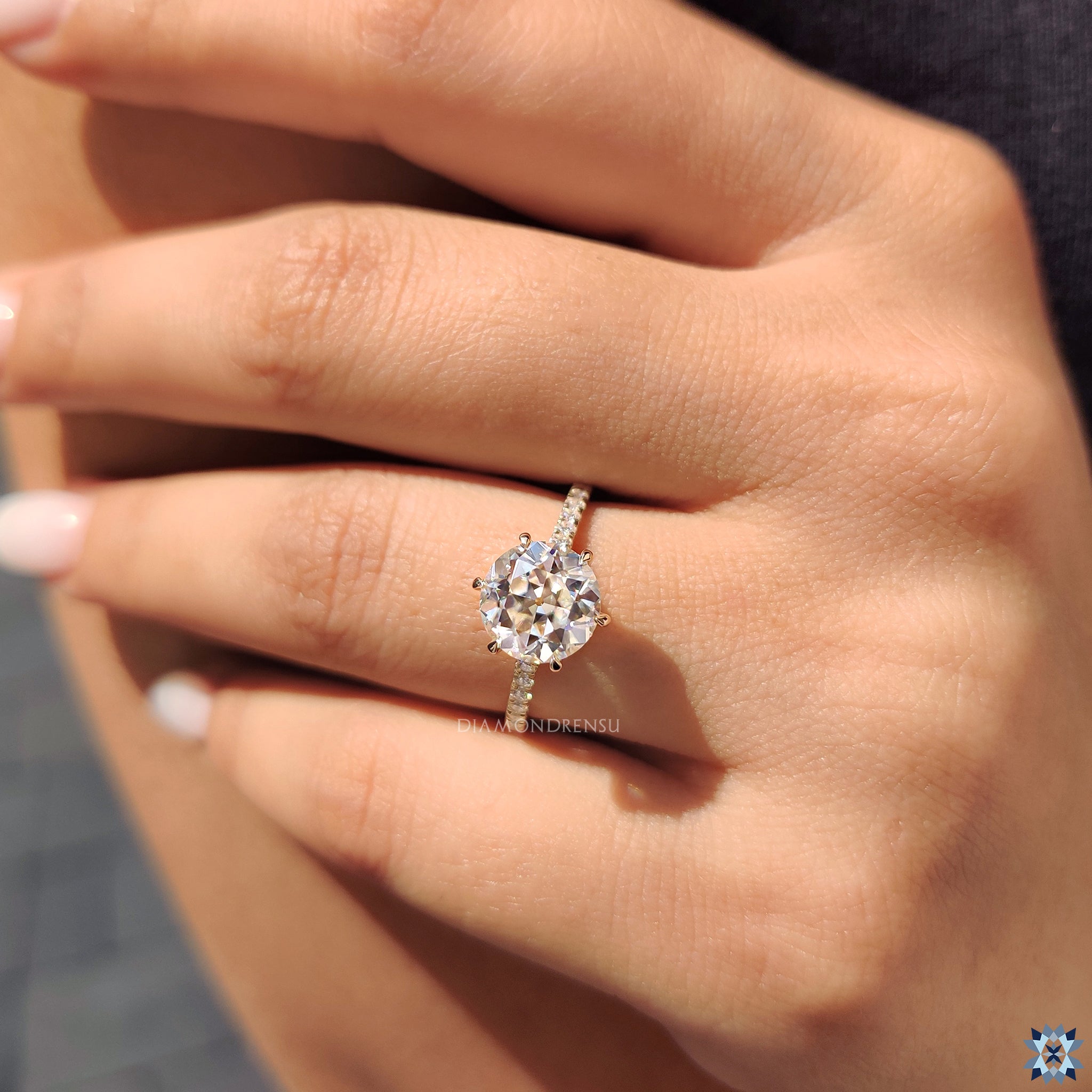 Yellow gold engagement ring featuring moissanite and handcrafted pave detail.
