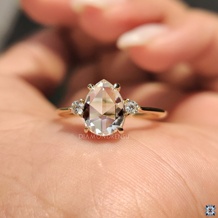 Round cut ring in three stone engagement ring style
