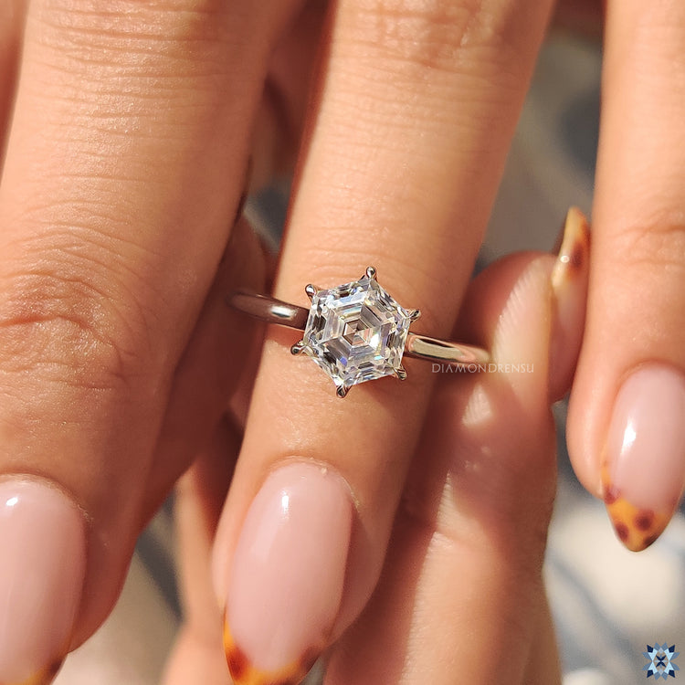 Custom engagement ring in solitaire setting with a hexagon moissanite.
