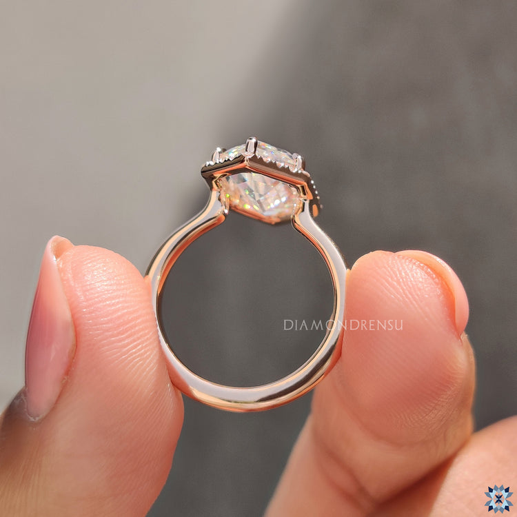 Moissanite engagement ring with round halo and open gallery for light.

