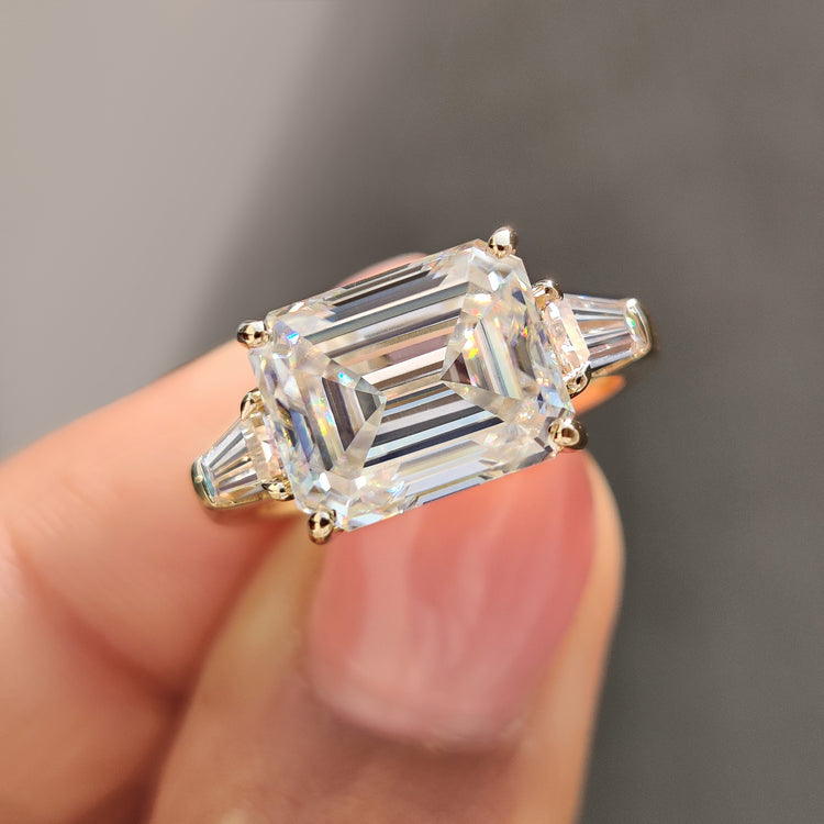 Emerald cut engagement ring set in East-West design with tapered baguettes.
