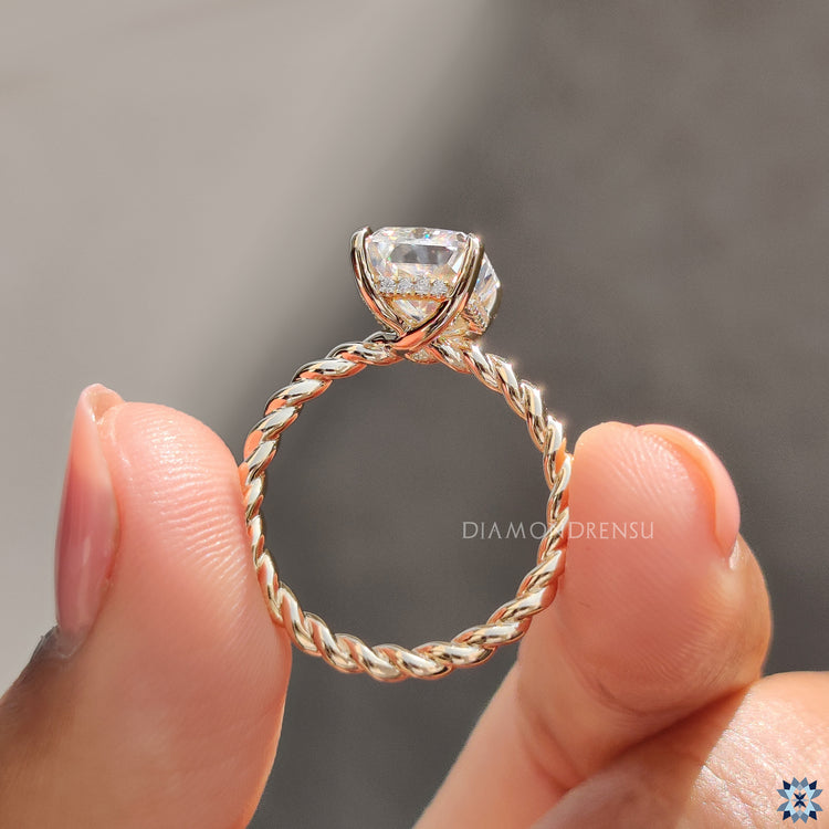 Radiant cut moissanite ring set in classic yellow gold prong design.
